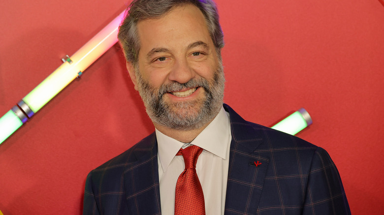 Judd Apatow smiling and wearing a suit