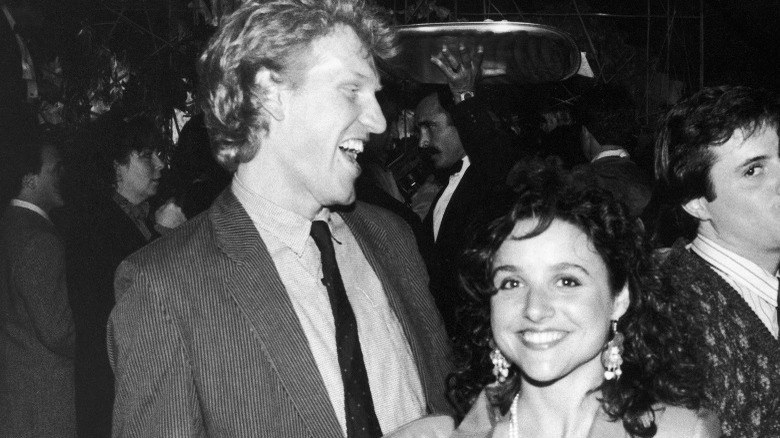 Brad Hall laughs as Julia Louis-Dreyfus smiles at the camera