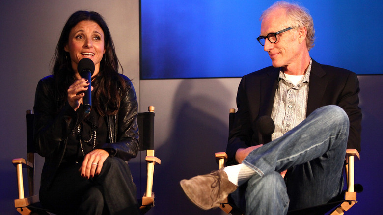 Julia Louis-Dreyfus speaks animatedly as Brad Hall smiles on