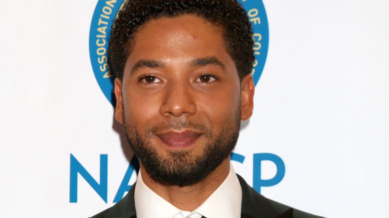 Jussie Smollett black suit beard smiling