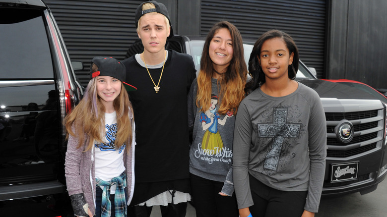 Justin Bieber posing sadly with fans