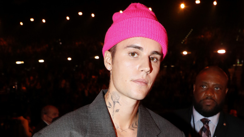 Justin Bieber posing pink beanie