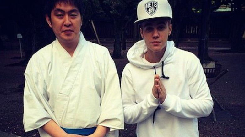 Justin Bieber posing at a shrine