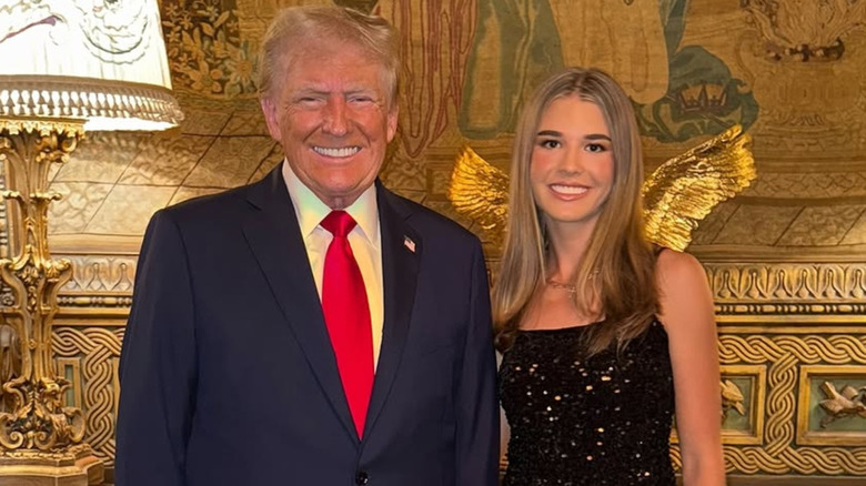 Donald Trump posing with granddaughter Kai Trump