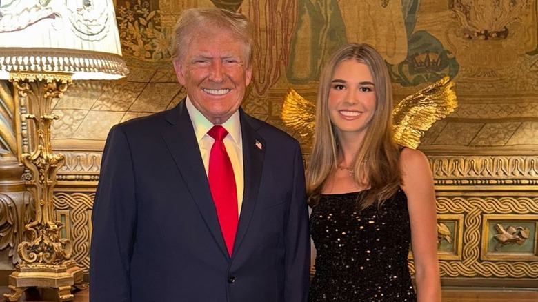 Donald Trump posing with granddaughter Kai Trump