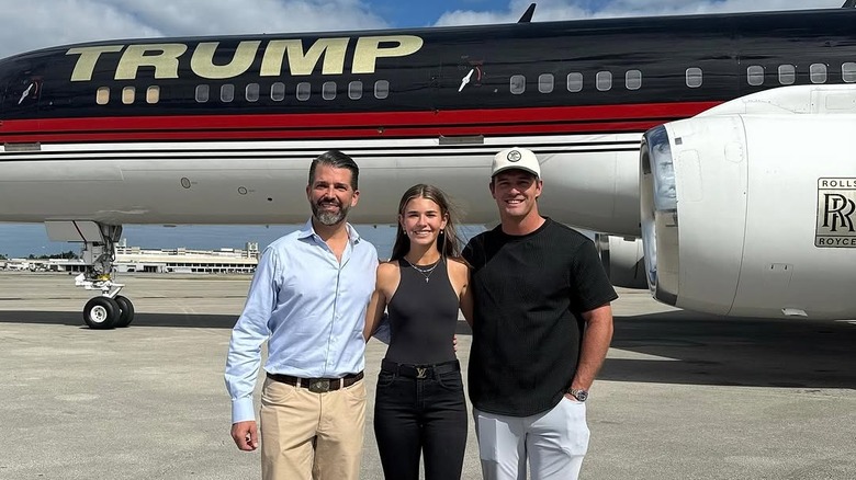 Kai Trump with Donald Trump Jr and Bryson Dechambeau in front of Trump jet