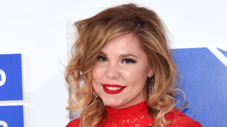 Kailyn Lowry smiling in red lipstick and a red top 