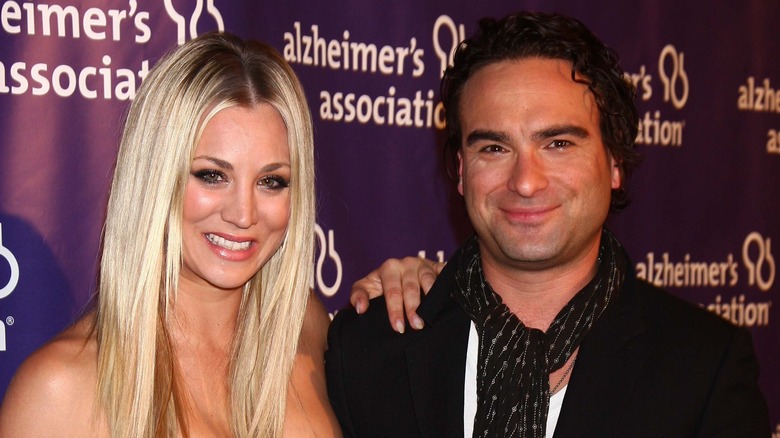 Kaley Cuoco smiling with hand on Johnny Galecki shoulder