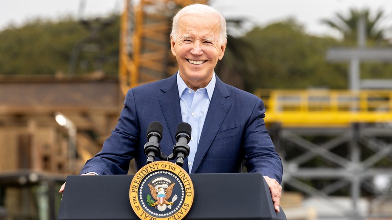 Joe Biden smiling behind podium