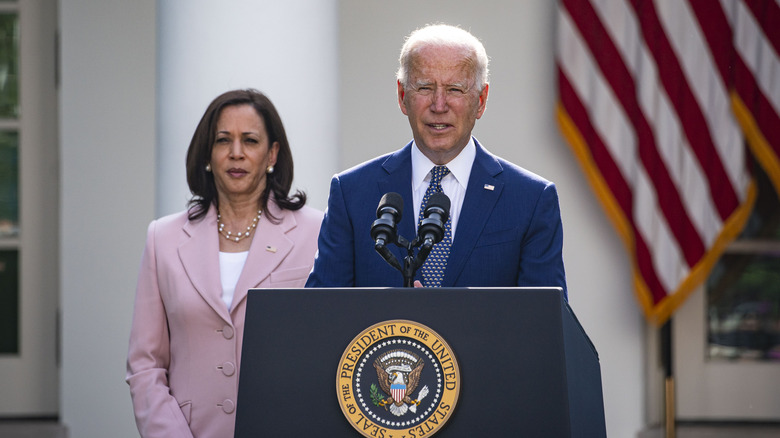 Joe Biden and Kamala Harris behind him