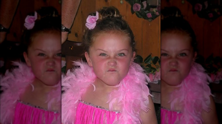 Young Ella Emhoff pouting in pink boa