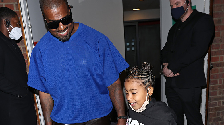 Kanye west smiling down at daughter north west