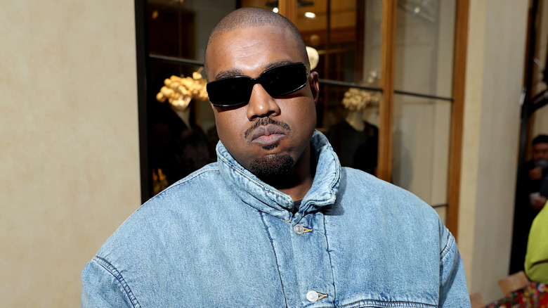 Kanye West wearing blue jacket