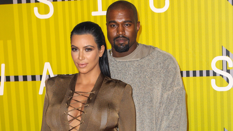 Kanye West and Kim Kardashian pose 