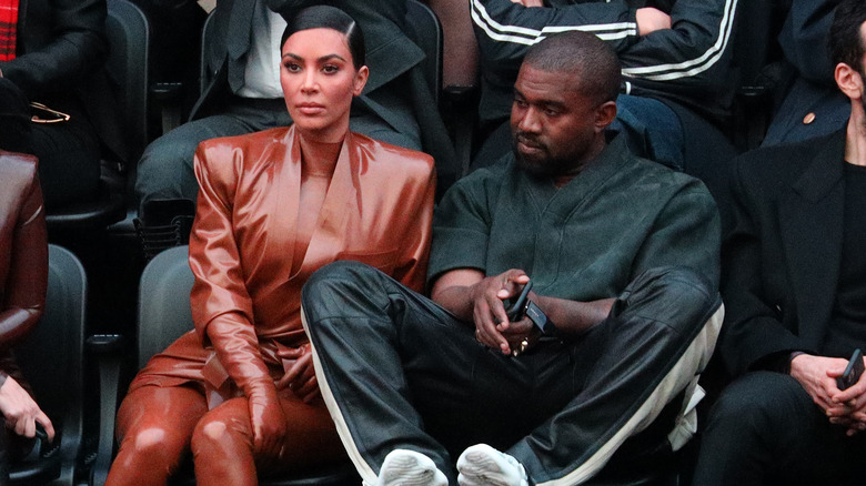 Kim Kardashian and Kanye West attending a basketball game