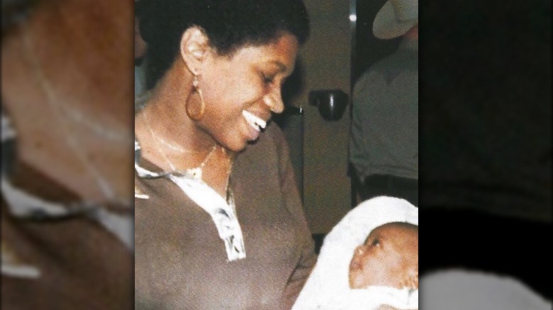 Donda West smiling at baby Kanye West