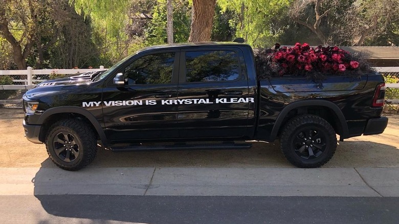 Black pickup truck filled with roses