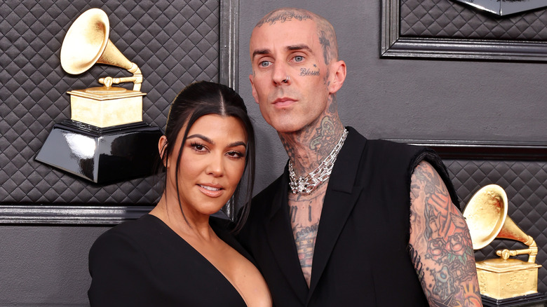 Kourtney Kardashian, Travis Barker posing