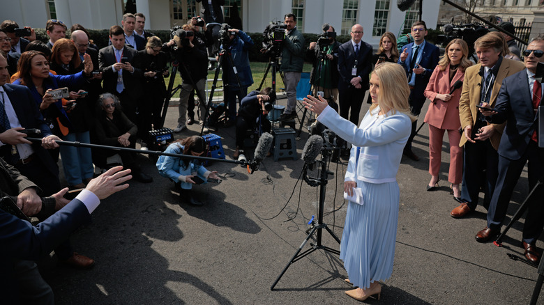 Karoline Leavitt talking to reporters following a television interview outside the West Wing