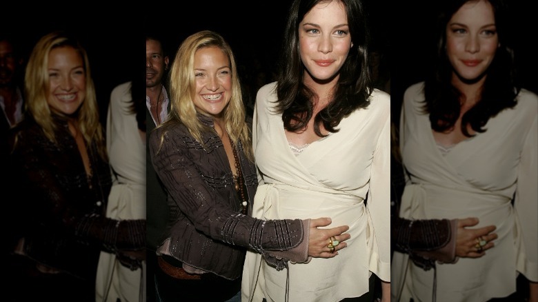 Kate Hudson holding Liv Tyler's pregnant belly