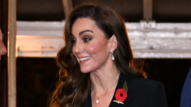 Kate Middleton smiling wide with head turned sideways