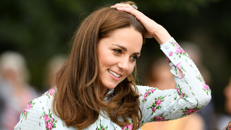 Kate Middleton with her hand on her head