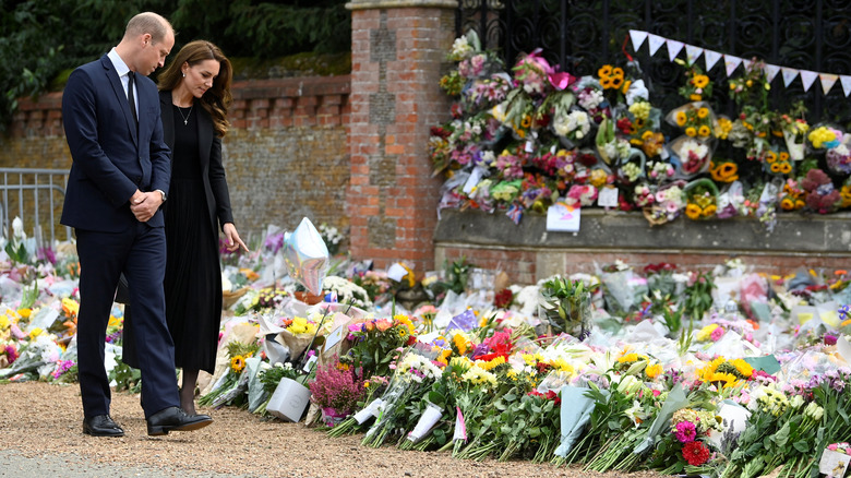 Prince William and Kate Middleton looking at flowers