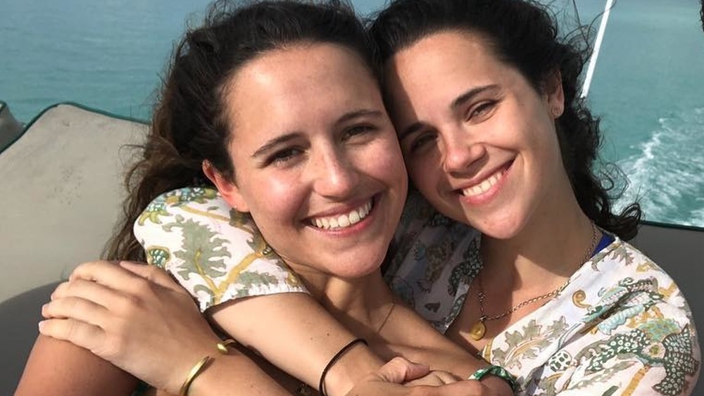 Ellie and Carrie Monahan hug on a boat