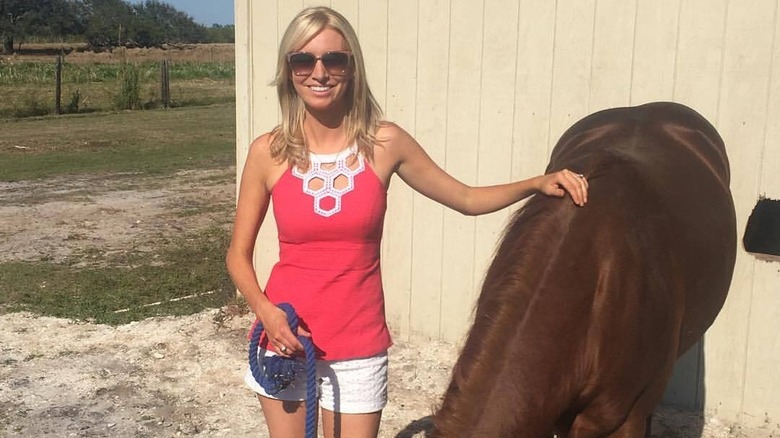 Kayleigh McEnany posing with a horse