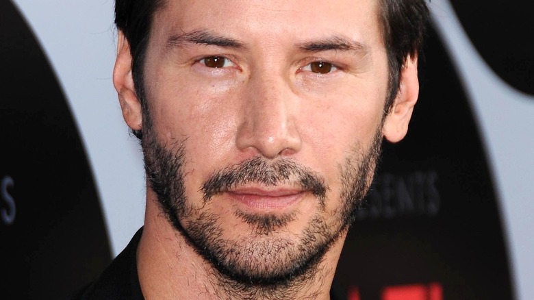 Keanu Reeves with a slight smile