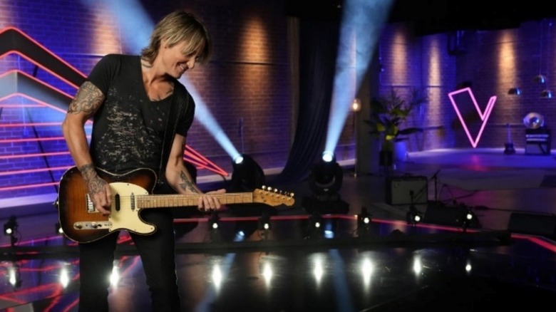 Keith Urban playing his guitar on The Voice