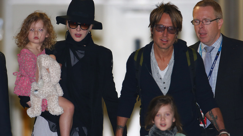 Keith Urban and Nicole Kidman walking with their daughters