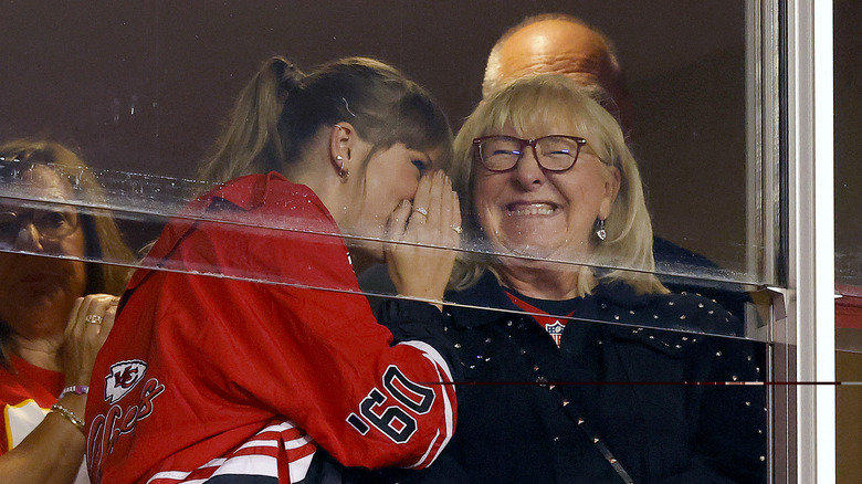 Taylor Swift whispering to Donna Kelce