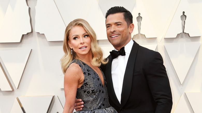 Kelly Ripa holding Mark Consuelos 