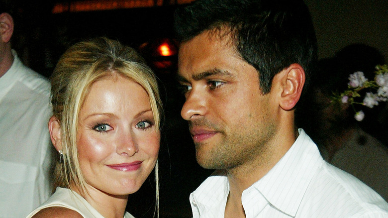 Kelly Ripa smiling Mark Consuelos serious