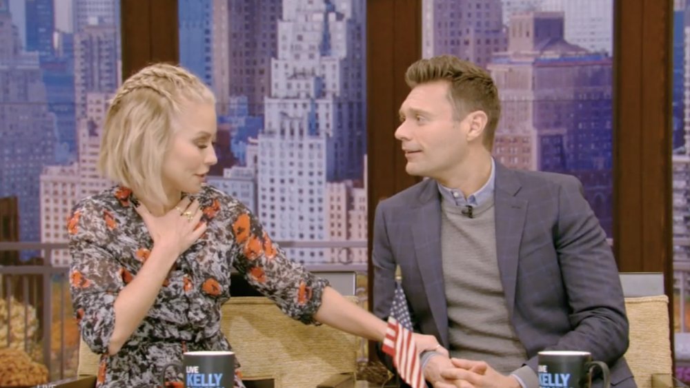 Kelly Ripa grabbing Ryan Seacrest's hand on air