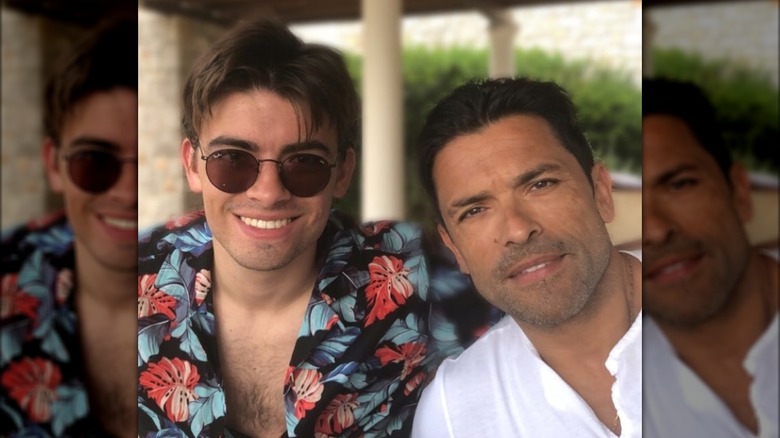 Michael Consuelos smiling beside Mark Consuelos