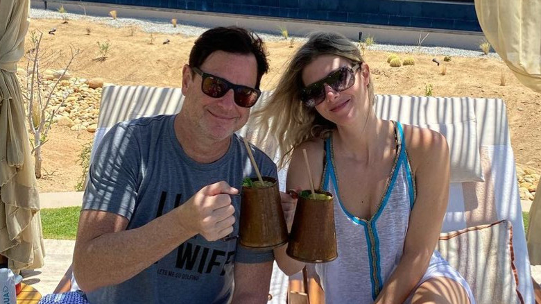 Bob Saget and Kelly Rizzo pose on vacation