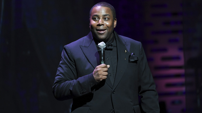 Kenan Thompson on stage hold microphone