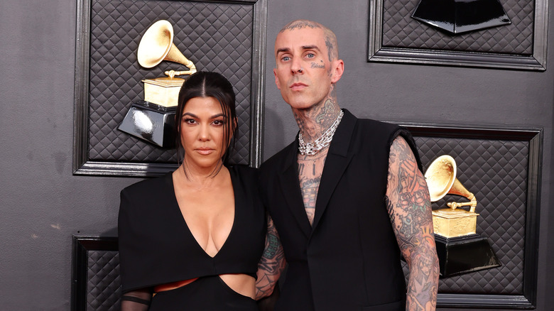 Kourtney Kardashian and Travis Barker pose 