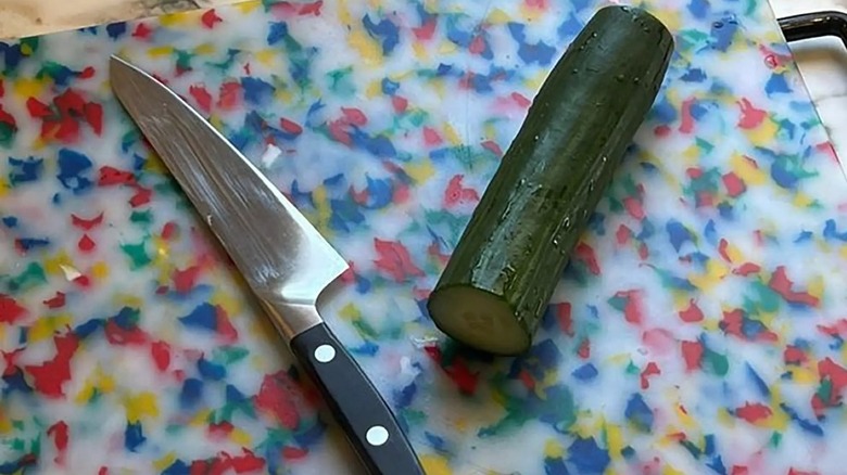 Cucumber and knife on a cutting board