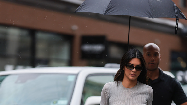 Kendall Jenner under umbrella