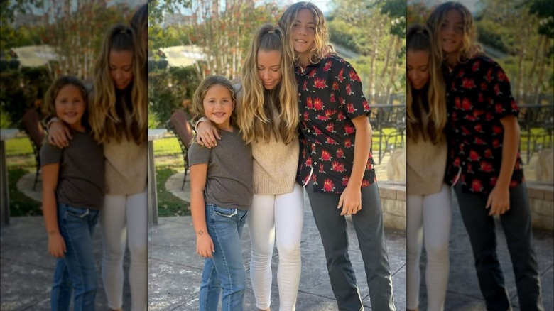 Kendra Wilkinson outdoors with daughter and son