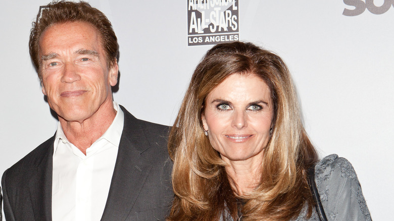 Arnold Schwarzenegger and Maria Shriver smiling on red carpet