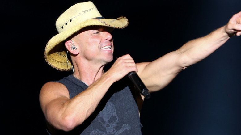 Kenny Chesney sings into a microphone