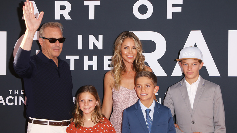 Kevin Costner, Christine Baumgartner, and their children smiling