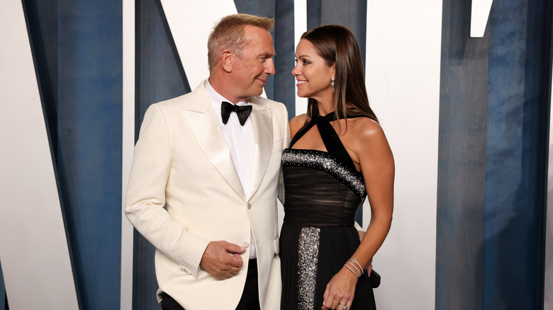 Kevin Costner and Christine Baumgartner pose 