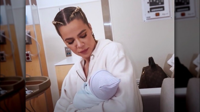 Khloe Kardashian holding her baby