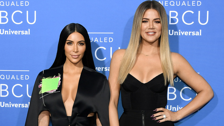 Khloe and Kim pose together at an event