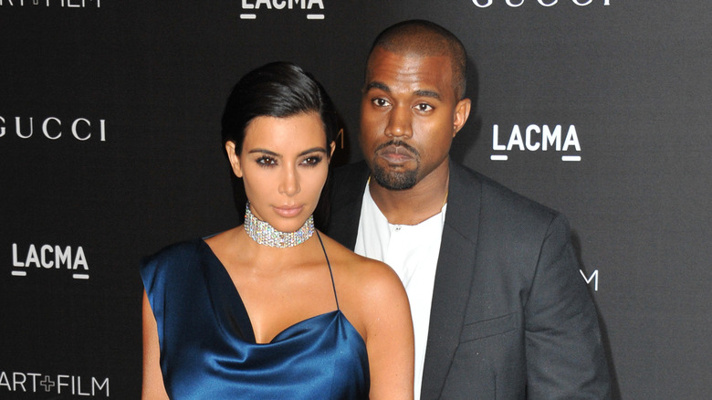 Kim Kardashian and Kanye West with serious expressions